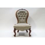 A Victorian walnut button back nursing chair with spoon back on cabriole legs