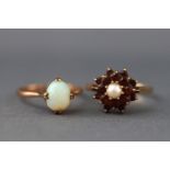 A selection of two dress rings to include a yellow metal single stone cabochon opal ring,