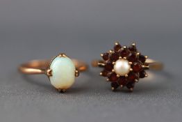 A selection of two dress rings to include a yellow metal single stone cabochon opal ring,