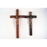 An ebonised crucifix with cast metal figure of Christ, 26cm high, and another mahogany example,