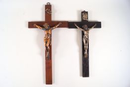 An ebonised crucifix with cast metal figure of Christ, 26cm high, and another mahogany example,