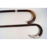 Two walking sticks, one with silver collar (London 1919),