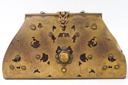 An early 20th century pierced brass clutch bag mounted with yellow glass stones
