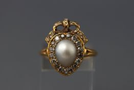 A late 19th century yellow metal pearl and diamond cluster ring set with a central light grey pear