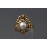 A late 19th century yellow metal pearl and diamond cluster ring set with a central light grey pear