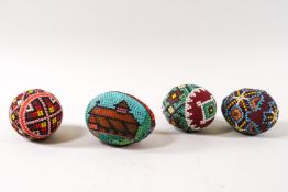 Four Romanian decorative beadwork eggs,