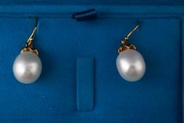 A 9ct and silver gilt pair of drop earrings.