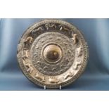 An Indian round white metal plate embossed with animals,