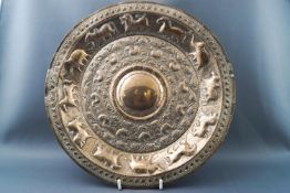 An Indian round white metal plate embossed with animals,