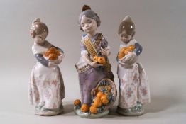 Three Lladro figures: Miss Valencia, 20cm high, with box, and a pair of girls holding oranges, 17.