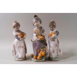 Three Lladro figures: Miss Valencia, 20cm high, with box, and a pair of girls holding oranges, 17.