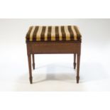 An Edwardian mahogany piano stool with satinwood cross banding on square tapering legs with spade