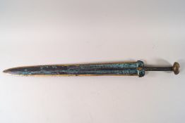 A reproduction Oriental bronze short sword with decoration to the blade,