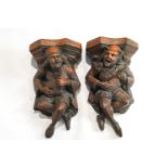 A pair of terracotta wall gargoyles, each playing a musical instrument,