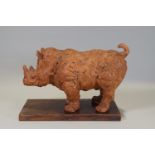 Ron Olley - A terracotta figure of a rhinocerous,