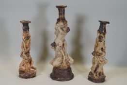 Ron Olley - Three ceramic candlesticks in the form of entwined male and female nudes, one 40cm high,