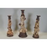 Ron Olley - Three ceramic candlesticks in the form of entwined male and female nudes, one 40cm high,