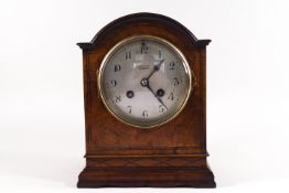 A domed walnut bracket clock by Stewart of Glasgow