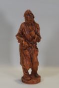 Ron Olley - A terracotta figure, self portrait in a dressing gown,