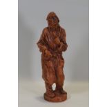Ron Olley - A terracotta figure, self portrait in a dressing gown,