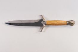 A steel bladed dagger with brass mounted beechwood hilt, the blade stamped indistinctly,