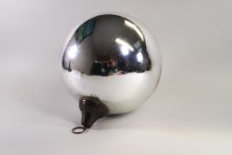 A silvered witches ball of large proportions