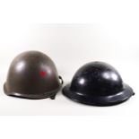 An American Army tin helmet and an English WW Army helmet