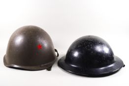 An American Army tin helmet and an English WW Army helmet