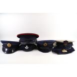 Six, various military caps, including Naval,