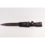 A steel bayonet style dagger with wood handle in a metal scabbard and leather belt fitment,