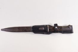 A steel bayonet style dagger with wood handle in a metal scabbard and leather belt fitment,