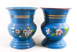 A pair of similar baluster urn vases in enamel on metal, decorated with banding and floral sprays,