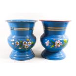 A pair of similar baluster urn vases in enamel on metal, decorated with banding and floral sprays,