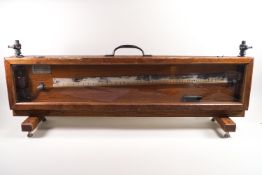 A wooden cased Negretti & Zambra spirit level, 30cm high,