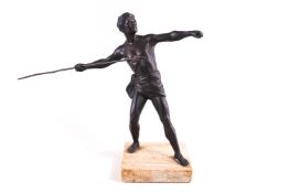 A cast metal figure of a male classical athlete hurling a spear, raised on a marble base,