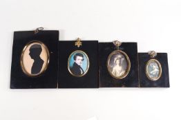 A group of three decorative miniatures and a silhouette in black Japanned frames