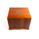 A bow fronted hardwood humidor with fitter interior and integral musical movement,