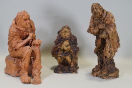 Ron Olley - A terracotta figure of a seated beggar, 28cm higha nd two ceramic en suite,