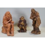 Ron Olley - A terracotta figure of a seated beggar, 28cm higha nd two ceramic en suite,