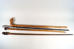 A hardstone headed malacca walking stick and three others.