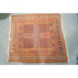 A rug with repeating geometric motifs within multiple borders on a red ground,