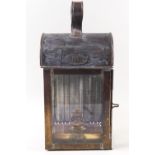 An LMS brass cased oil lamp of rectangular form with arched lid set a strap handle 32 cms