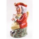 A 19th century Staffordshire pottery Toby jug, painted with coloured enamels,
