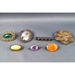 A selection of seven silver brooches, some marked as sterling,