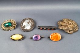 A selection of seven silver brooches, some marked as sterling,