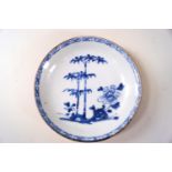 A Nanking cargo porcelain saucer, painted in underglaze blue with a peony and bamboo,