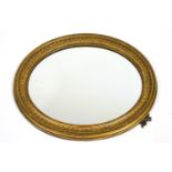 A Victorian oval gilt frame, now with mirror glass,