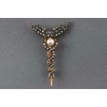 A yellow and white metal brooch set with a single cultured pearl and single cut diamonds.