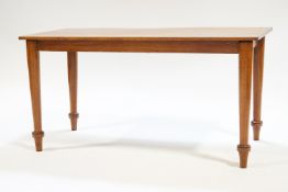 A large mahogany coffee table with rectangular top, raised on turned legs,