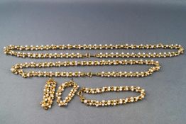 A collection of gold plated necklace, bracelet and earring set made from beads and simulated pearls.